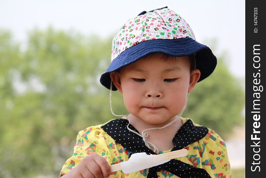 In the beautiful summer, there was a little girl eat ice cream. In the beautiful summer, there was a little girl eat ice cream