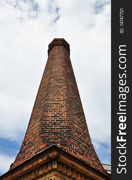 Brick chimney against blue sky.