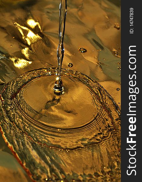 Background of water dripping on gold paper. Background of water dripping on gold paper