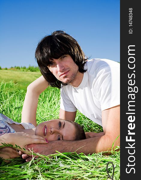 Beautiful girl and boy in white t-shirt on grass. Beautiful girl and boy in white t-shirt on grass