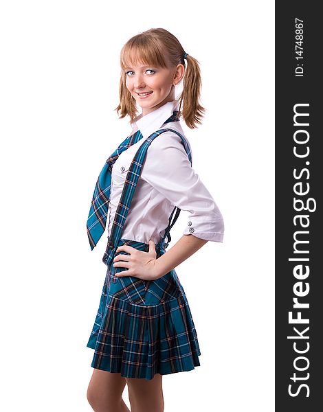 A young and beautiful schoolgirl is wearing a traditional uniform is smiling on white background. Senior high school student in uniform is posing