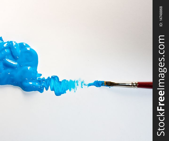 Paintbrush while painting a blue color. Paintbrush while painting a blue color