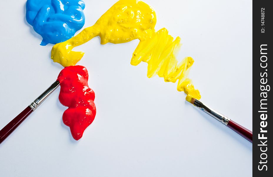 Paintbrushes and red, yellow and blue colors on a white background. Paintbrushes and red, yellow and blue colors on a white background