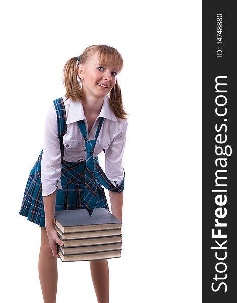 Schoolgirl is holding the stack of book.