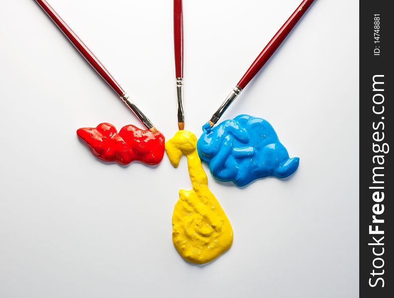 Paintbrushes and red, yellow and blue colors on a white background. Paintbrushes and red, yellow and blue colors on a white background