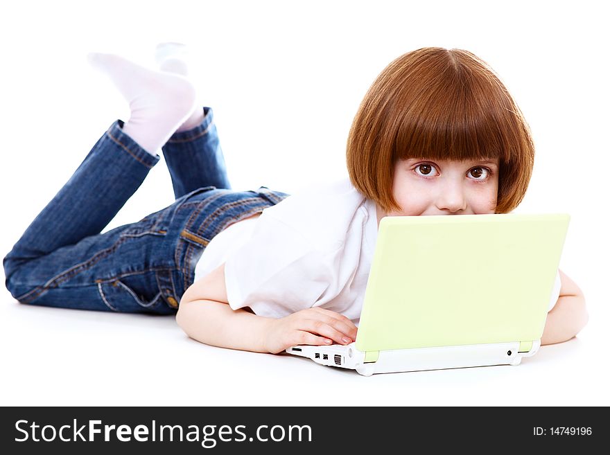 Little girls with a laptop over white; shallow DOF, focus on eyes