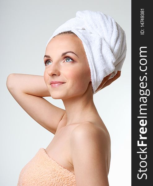 Young woman with white towel on her head. Looking upward. Young woman with white towel on her head. Looking upward.