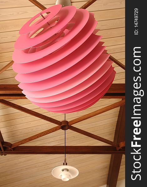 Pink modern lamp on the ceiling