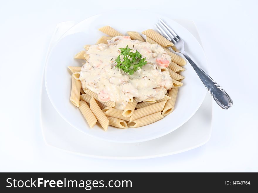 Penne with white sauce on a plate decorated with parsley