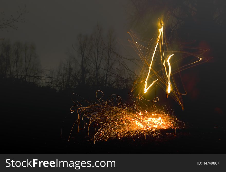 Star painting by fire in the dark. Star painting by fire in the dark