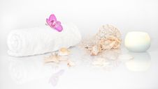 White Towel With Orchid, Seashells And A Candle Stock Photos White Towel With Orchid, Seashells And A Candle Stock Photos