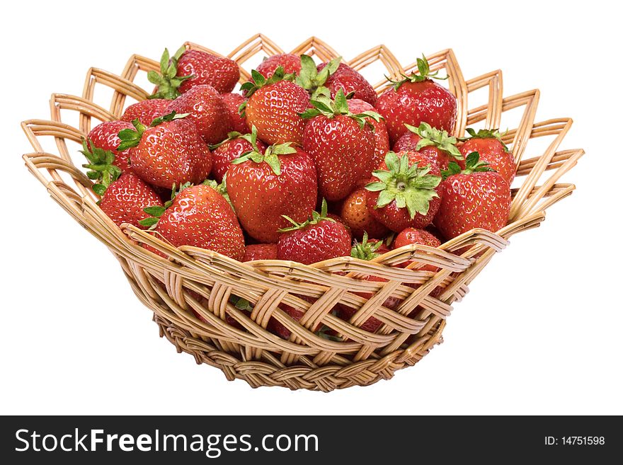 Ripe strawberries in a wicker basket isolated on white background
