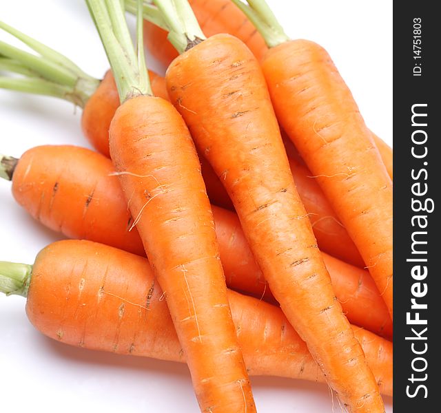 Ripe fresh carrots on a white background.