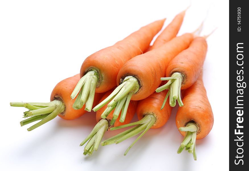 Ripe fresh carrots on a white background.