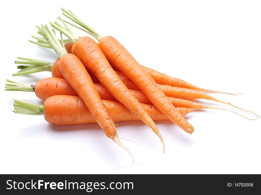 Ripe fresh carrots on a white background.