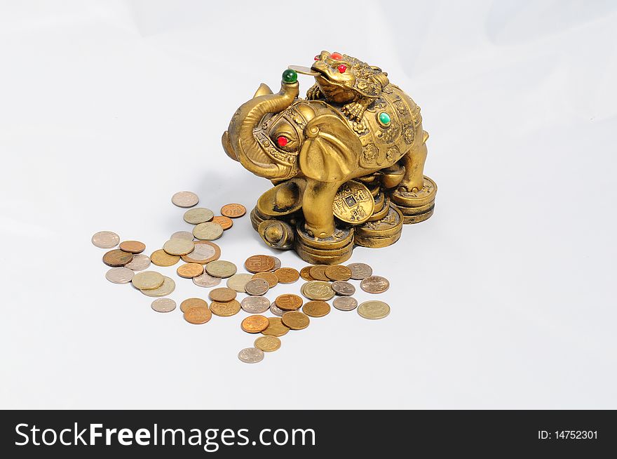 Ancient figurine bronze elephant with frog isolated on coins . Ancient figurine bronze elephant with frog isolated on coins .