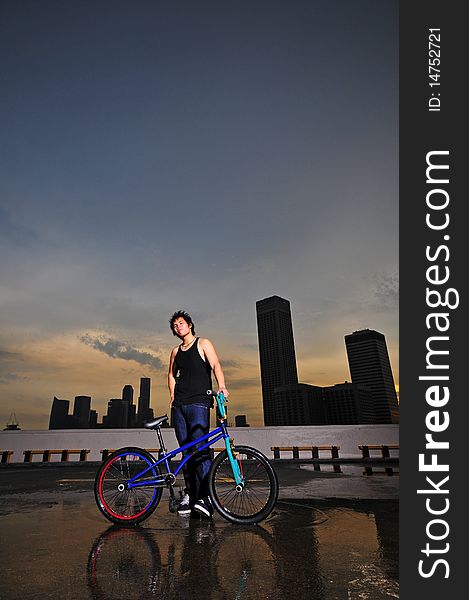 Picture of BMX flatland cyclist doing a stunt on a rooftop. Picture is useful for Gen X, Gen Y description of youths, their hobbies and how their lifestyle. Picture of BMX flatland cyclist doing a stunt on a rooftop. Picture is useful for Gen X, Gen Y description of youths, their hobbies and how their lifestyle