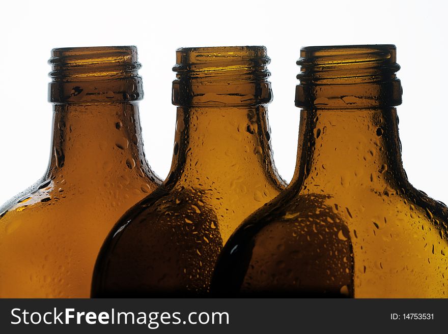 Three glass bottles on a white background