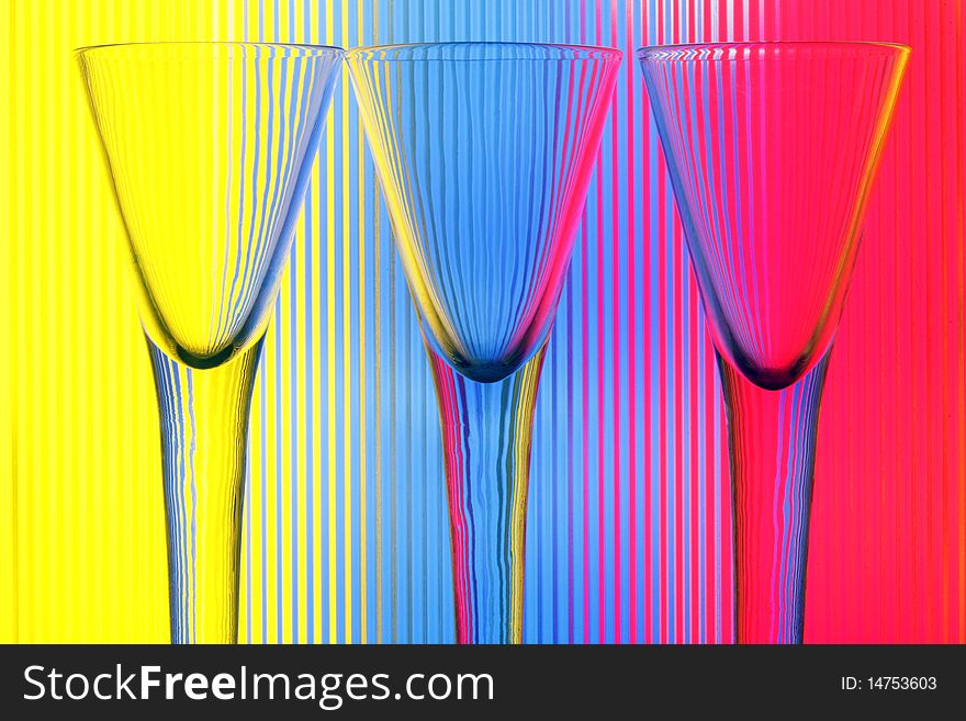 Three wine-glasses on a colour background