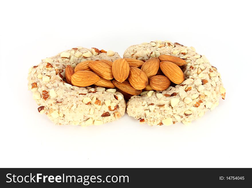 Homemade cakes in shape of crescent with some almonds, isolated on white