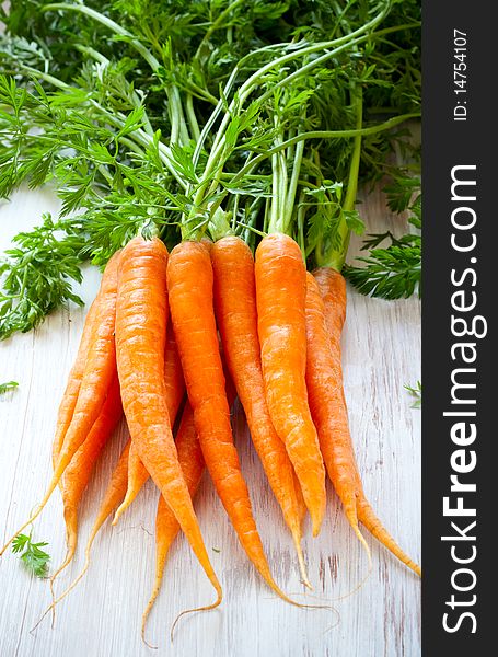 Fresh organic carrots on a wooden table