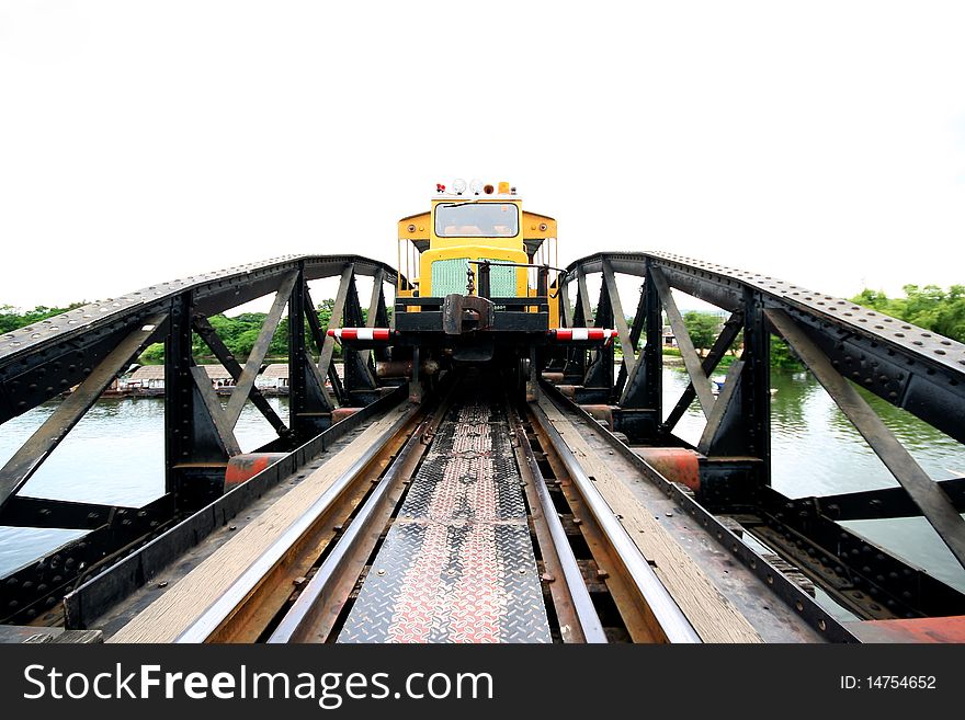 Train running across a river Quare bridge Thailand