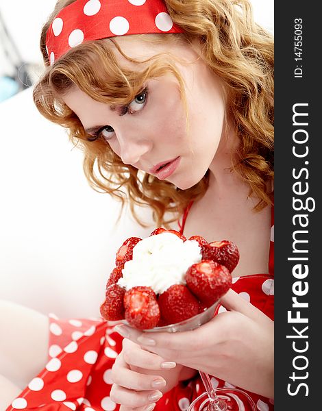 Young beautiful girl eating strawberries. Young beautiful girl eating strawberries