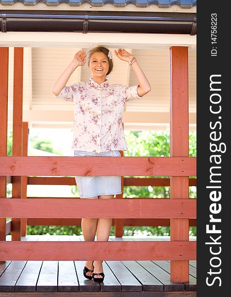 Girl Standing On A Veranda