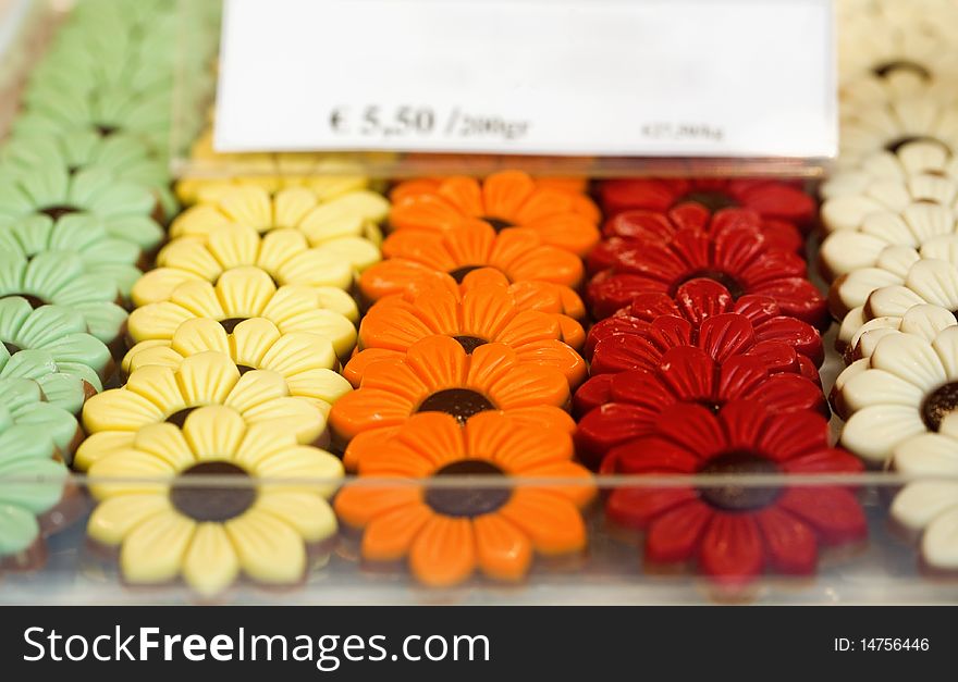 Colorful Belgian chocolate in the form of flowers on a shop window