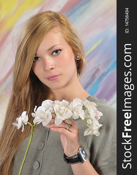 Portrait of long-haired beautiful girl 16-17 years with orchid. Portrait of long-haired beautiful girl 16-17 years with orchid