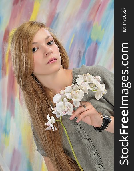 Portrait of long-haired beautiful girl 16-17 years with orchid. Portrait of long-haired beautiful girl 16-17 years with orchid