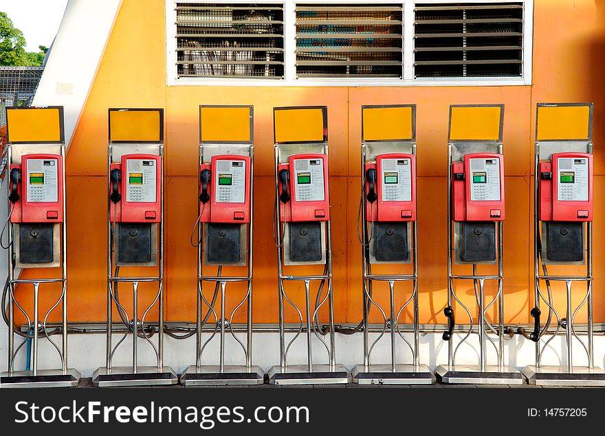 The red public telephone on the orange background