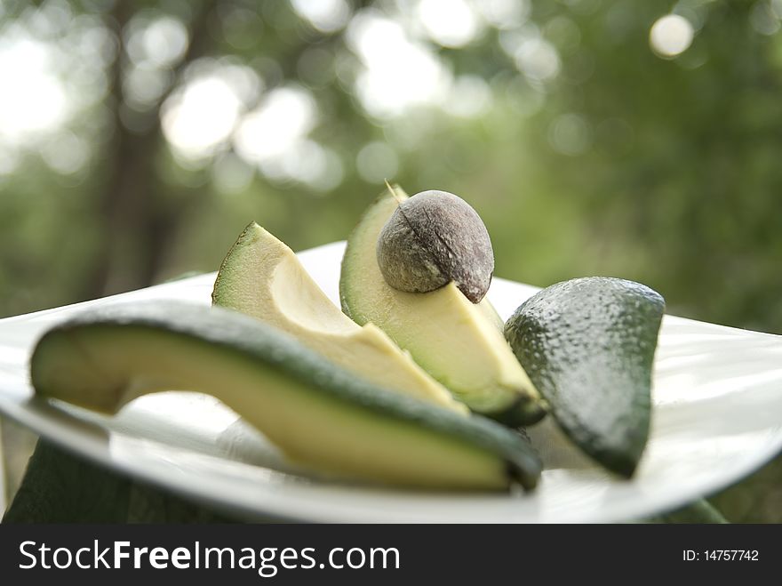 Ripe chopped avocado on a white plate