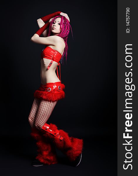 Trendy girl with red dreadlocks is dancing. Shot in a studio. Trendy girl with red dreadlocks is dancing. Shot in a studio.