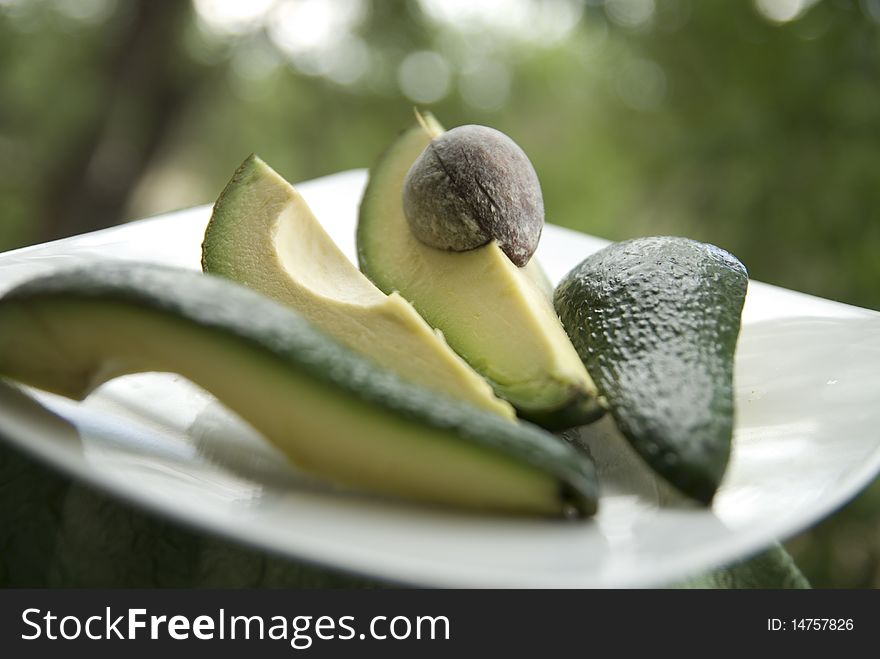 Ripe chopped avocado on a white plate. Ripe chopped avocado on a white plate