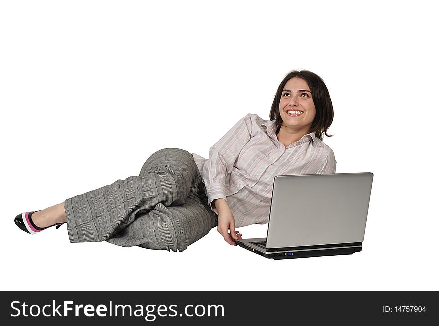 The beautiful girl laughs and lies on a floor with the laptop on a white background. The beautiful girl laughs and lies on a floor with the laptop on a white background