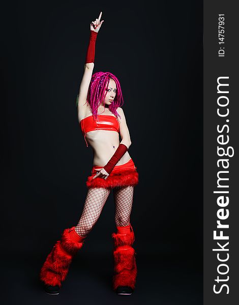 Trendy girl with red dreadlocks is dancing. Shot in a studio. Trendy girl with red dreadlocks is dancing. Shot in a studio.