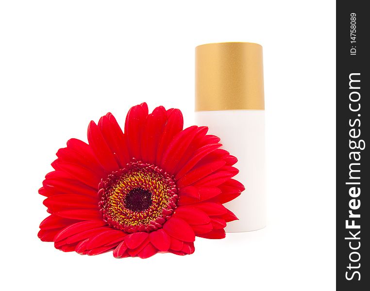 Cream bottle with a red gerberas on a white background