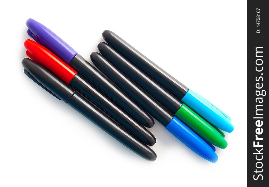 Set of multi-coloured pens on a white background