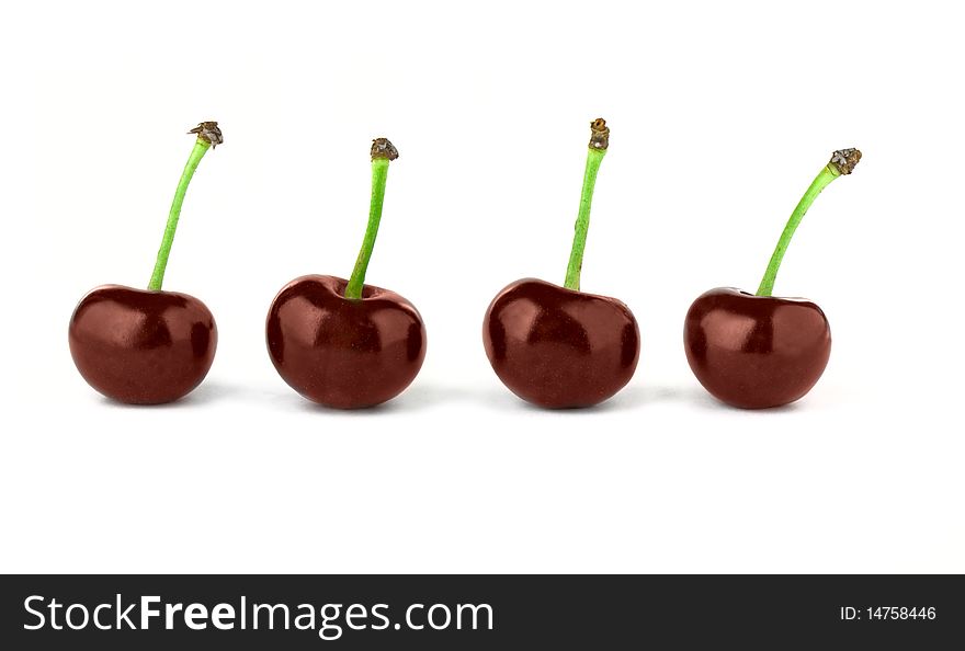 Four red cherries isolated on white background. Four red cherries isolated on white background