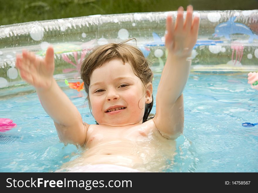 The beautiful child falls in pool and extends hands forward. The beautiful child falls in pool and extends hands forward