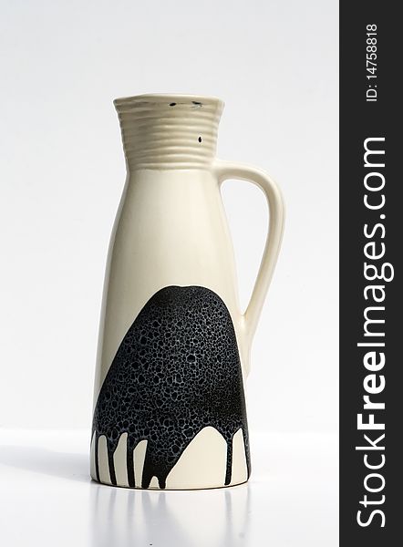 Israeli high and narrow white ceramic jug of 1950-th years with abstract black graphical image. The exquisite form in east style, strict design,glazed texture of the surface. Isolated on white. Israeli high and narrow white ceramic jug of 1950-th years with abstract black graphical image. The exquisite form in east style, strict design,glazed texture of the surface. Isolated on white.