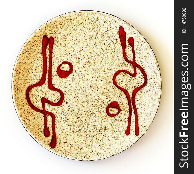 Closeup of Israeli ceramic circle plate of 1950th years with an image of the red graphical spots, reminding a human figures, on a light brown ceramic background. Closeup of Israeli ceramic circle plate of 1950th years with an image of the red graphical spots, reminding a human figures, on a light brown ceramic background.