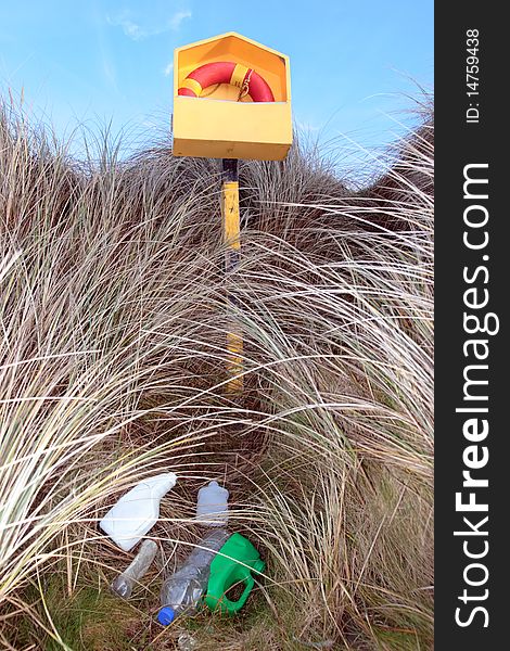 Rubbish next to a beach lifebuoy. Rubbish next to a beach lifebuoy