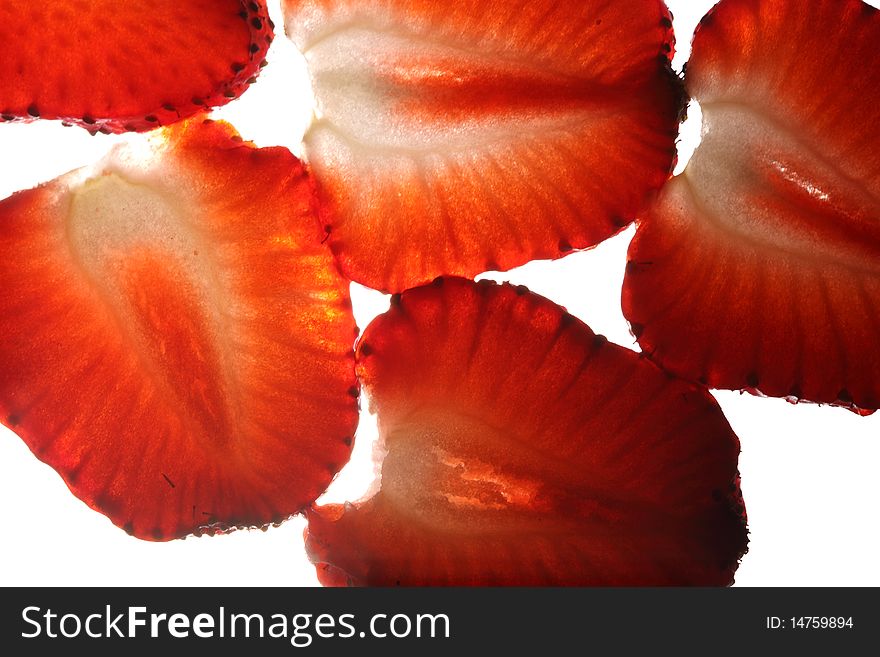 Close-up view of sliced strawberry in back light. Close-up view of sliced strawberry in back light