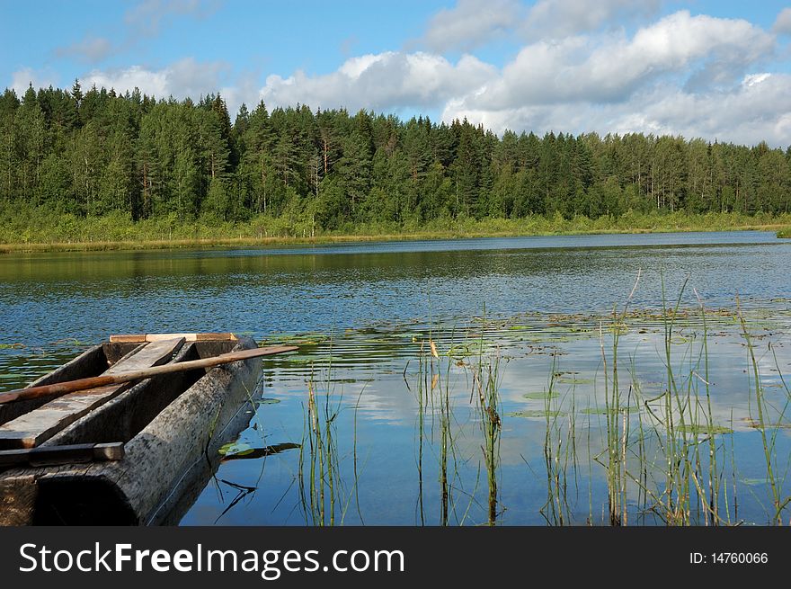 Little forest lake with old traditional wooden boat, north Russia. Little forest lake with old traditional wooden boat, north Russia
