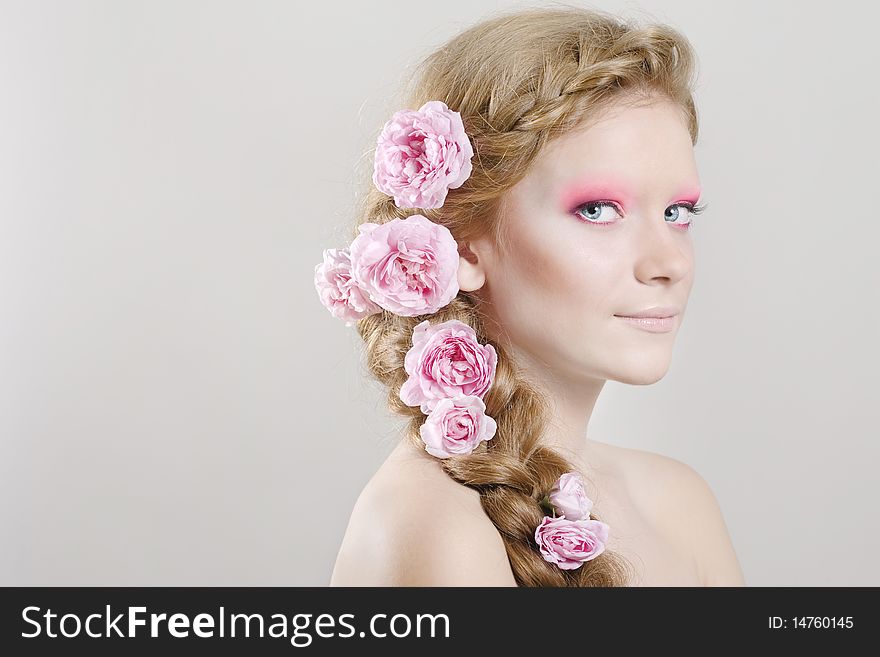 Portrait of young woman with with braids and flowers in hair. Portrait of young woman with with braids and flowers in hair