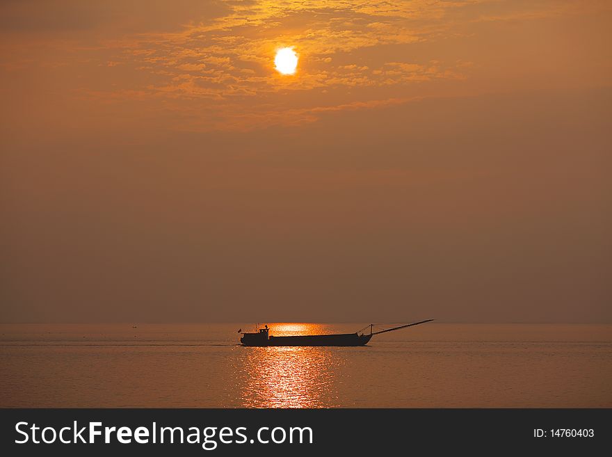 A boat is going forward at sunset