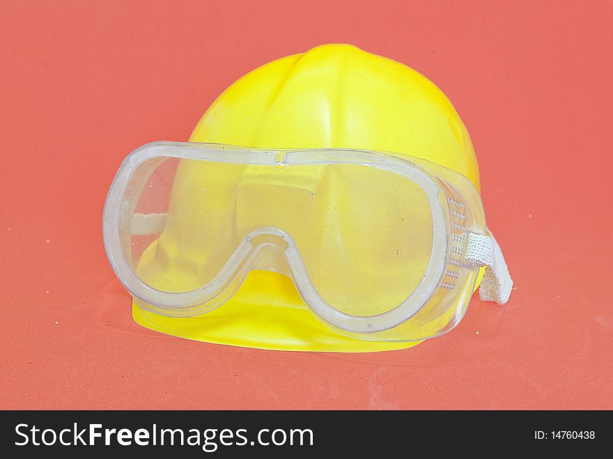 Yellow helmet with goggles red background