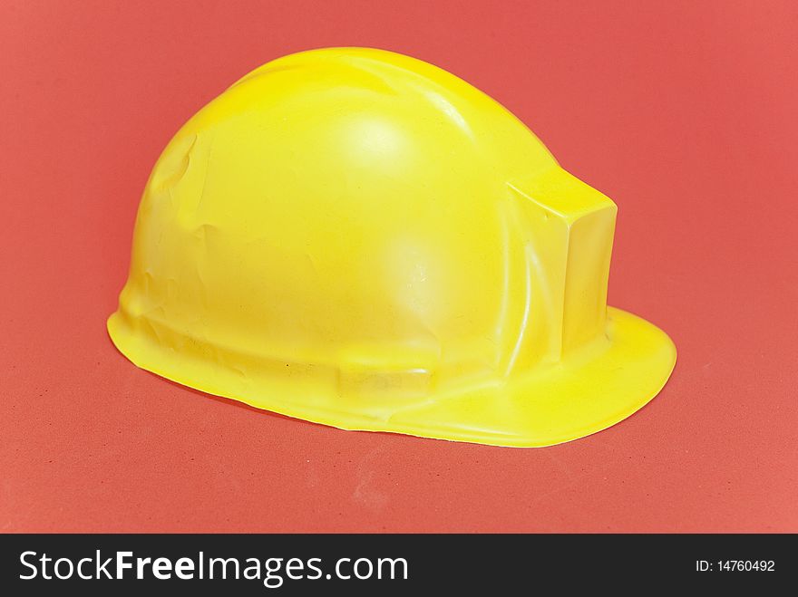 Yellow  helmet isolated on red background